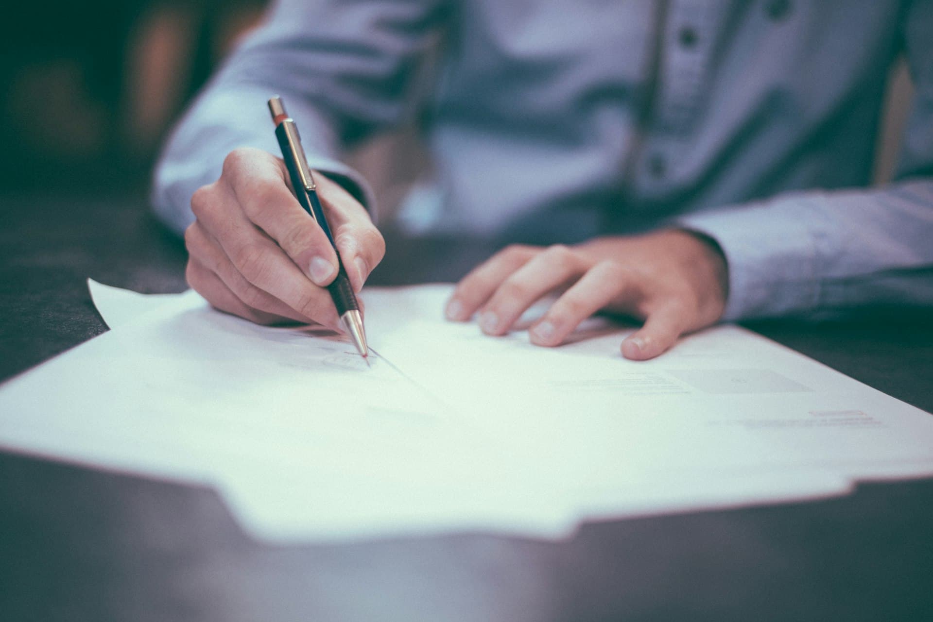 Hands holding a notebook with a plan