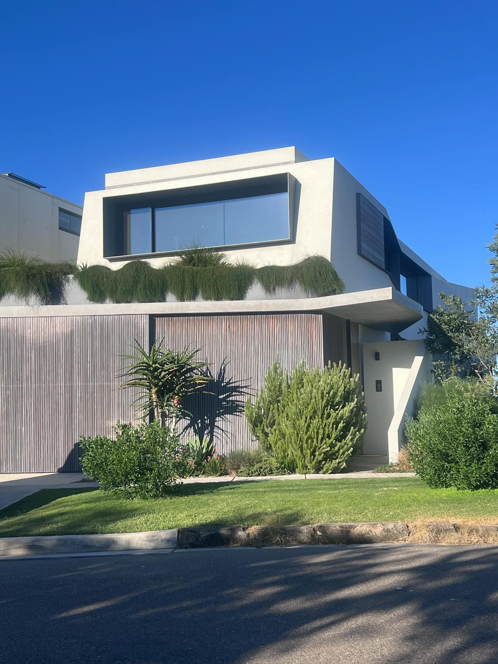 Modern coastal Australian home with rendered facade and timber cladding