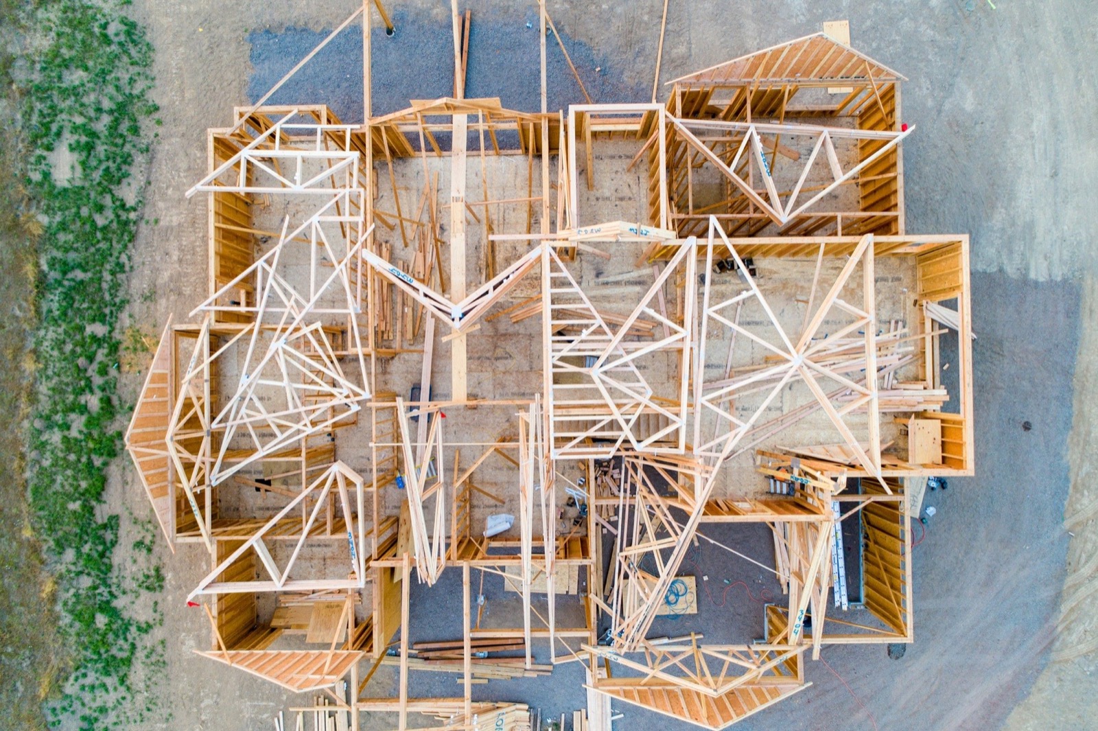A residential house under construction with timber framing visible.